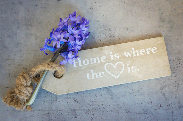 Flower and sign of home is where the heart is - Schill Insurance